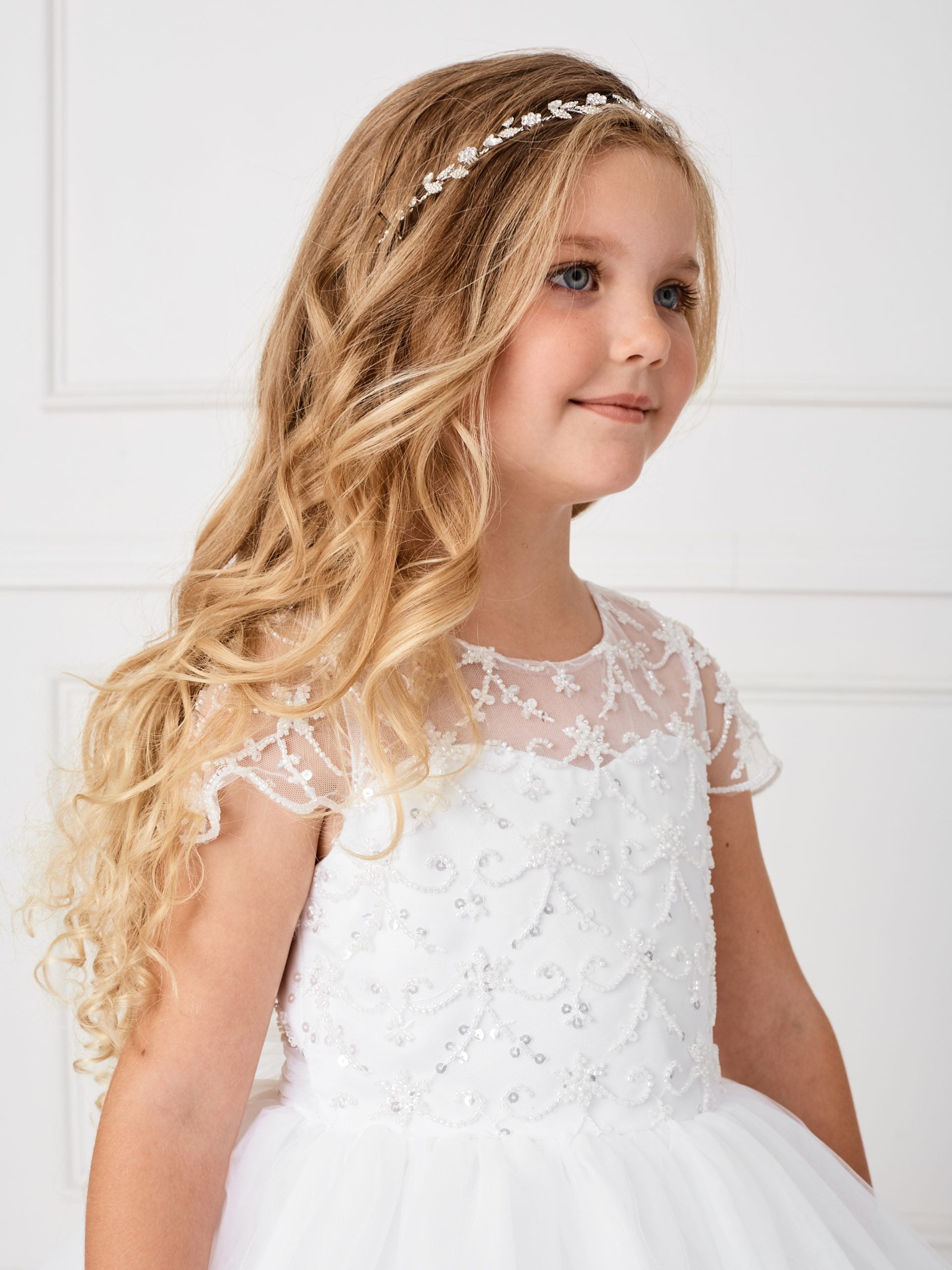 156 Girl wearing a crystal leaf headband for communion or wedding.