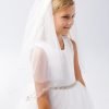 Girl wearing a girls communion veil with beads, styled with a white dress for her special day.
